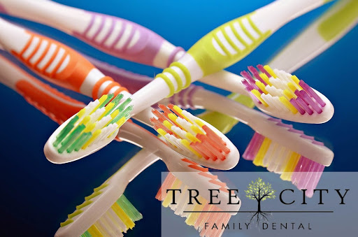 Colorful toothbrushes laying on top of each other